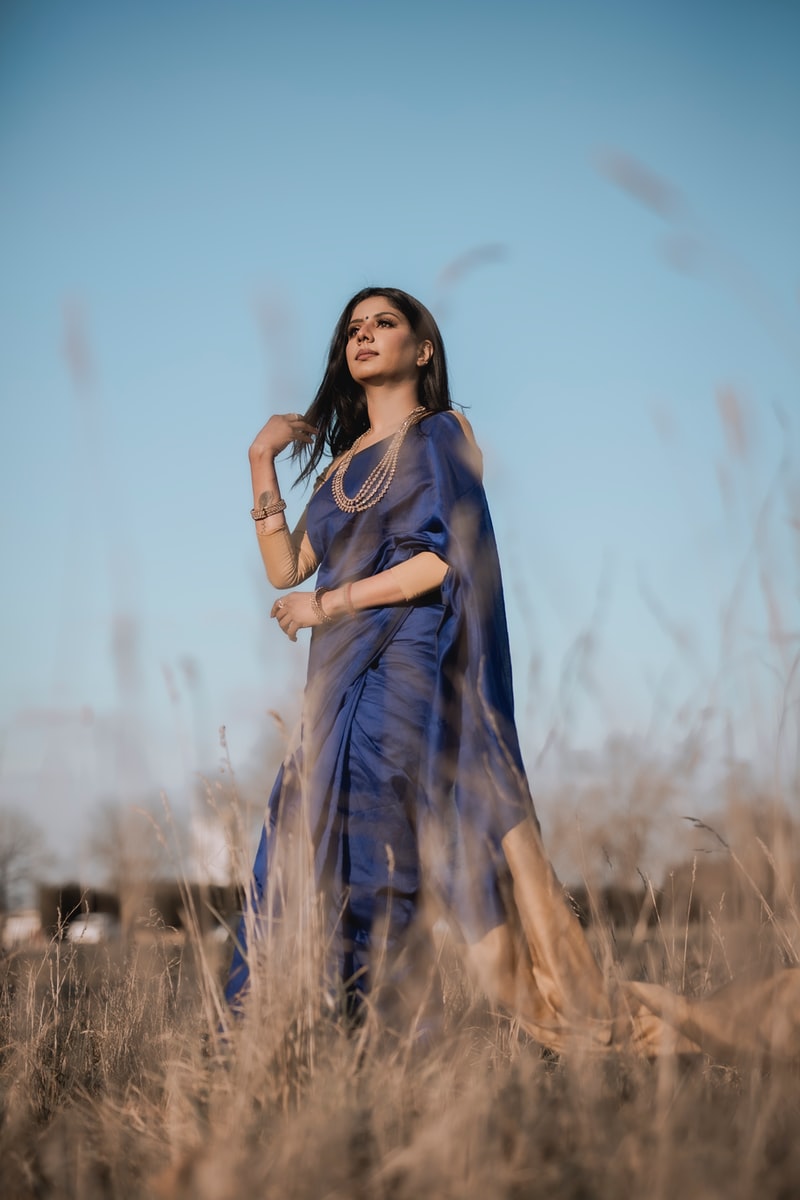 woman in blue dress standing on brown grass field during daytimeZOQLO® Best Gadwal  JGeorgette collection amdani 
